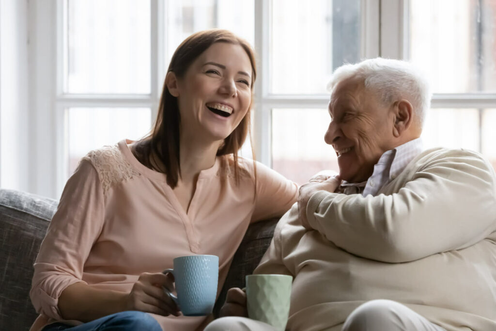 Proveer at Northgate | Senior and caregiver laughing over some coffee